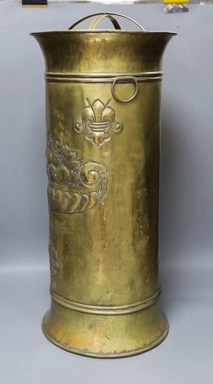 An embossed brass stick stand, 66cms high.